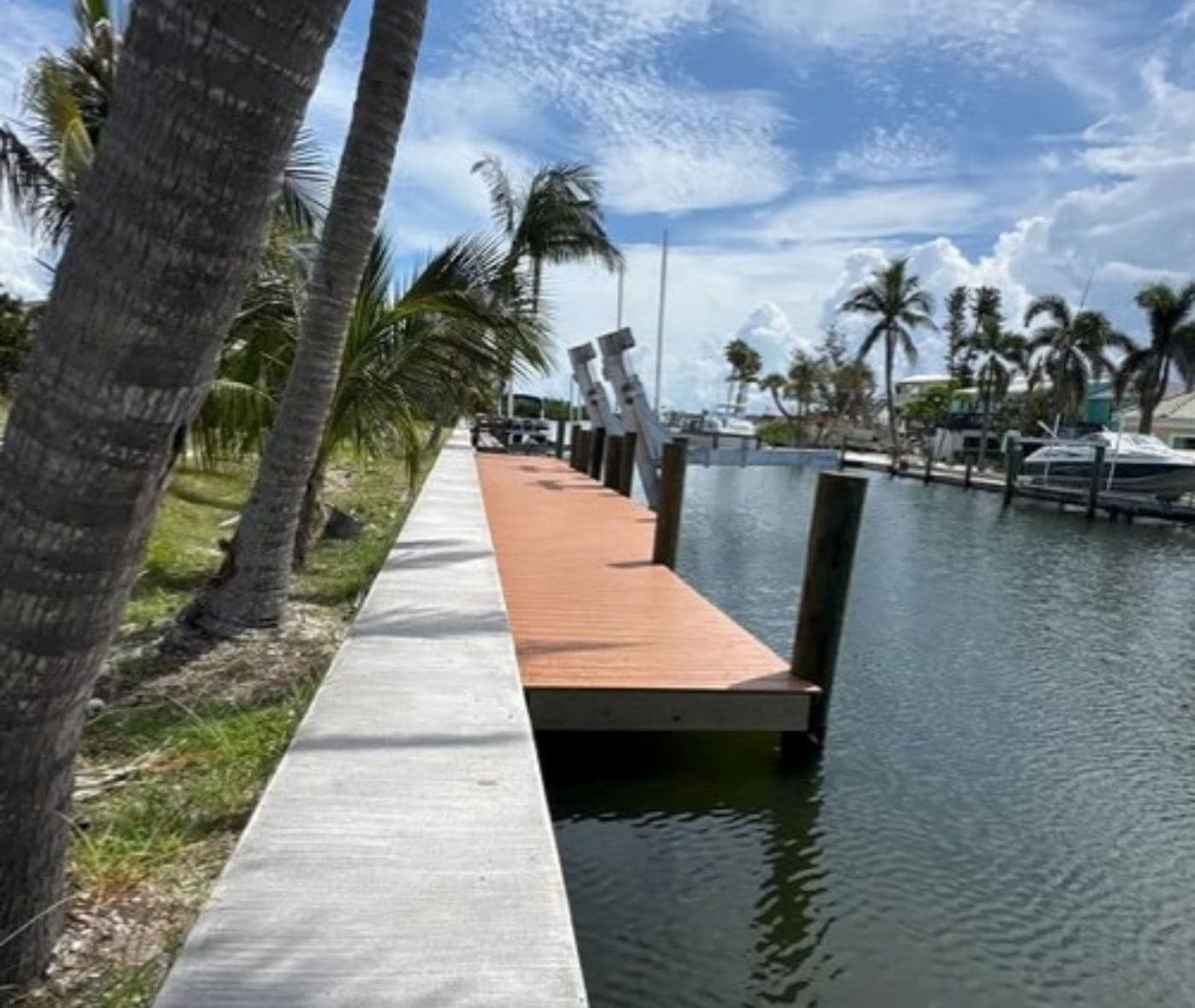 Concrete seawall cap and walkway along a residential canal