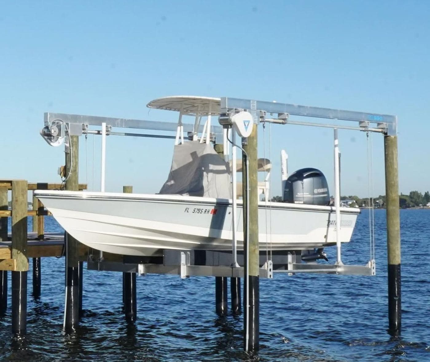 A center-console boat raised on a new aluminum boat lift