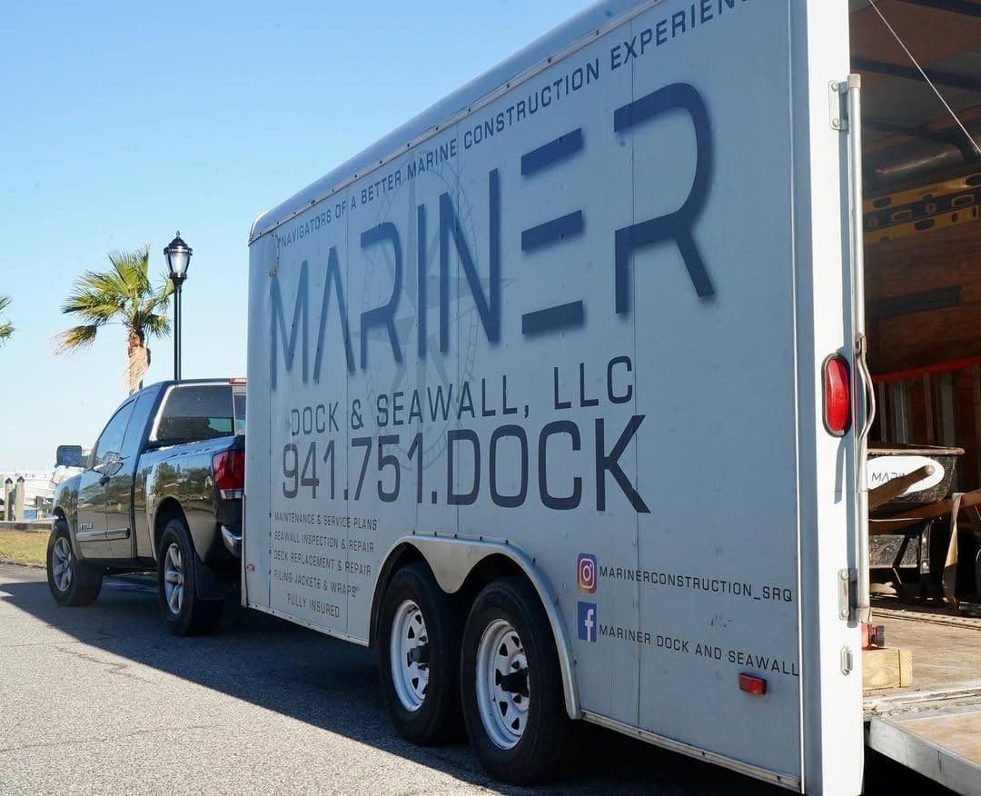The Mariner Dock & Seawall company trailer, lettered with 941.751.DOCK