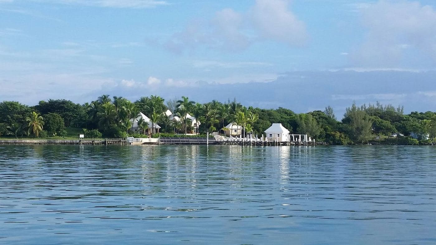 Open bay water with waterfront homes and docks along the far shoreline
