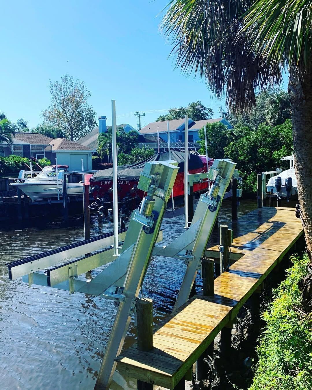 Boat lifts lined along a residential canal
