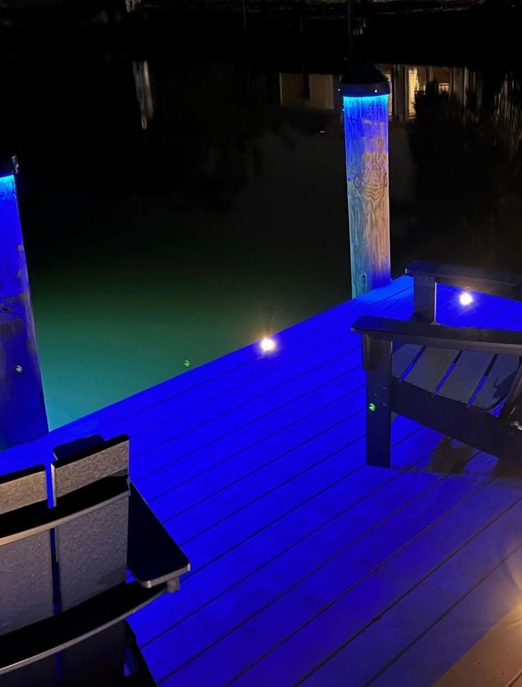 Blue LED dock lighting reflecting off decking at night