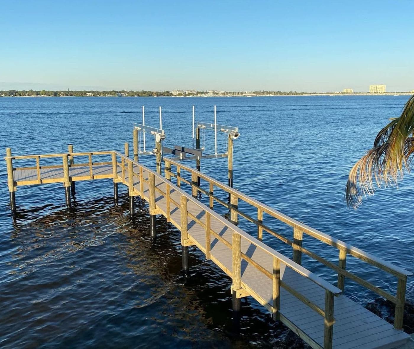 A Mariner-built dock with two boat lifts on open water